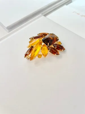 The Socialite and her love of the classic brooch. This 1960's faux glass smoky topaz brooch is truly divine!