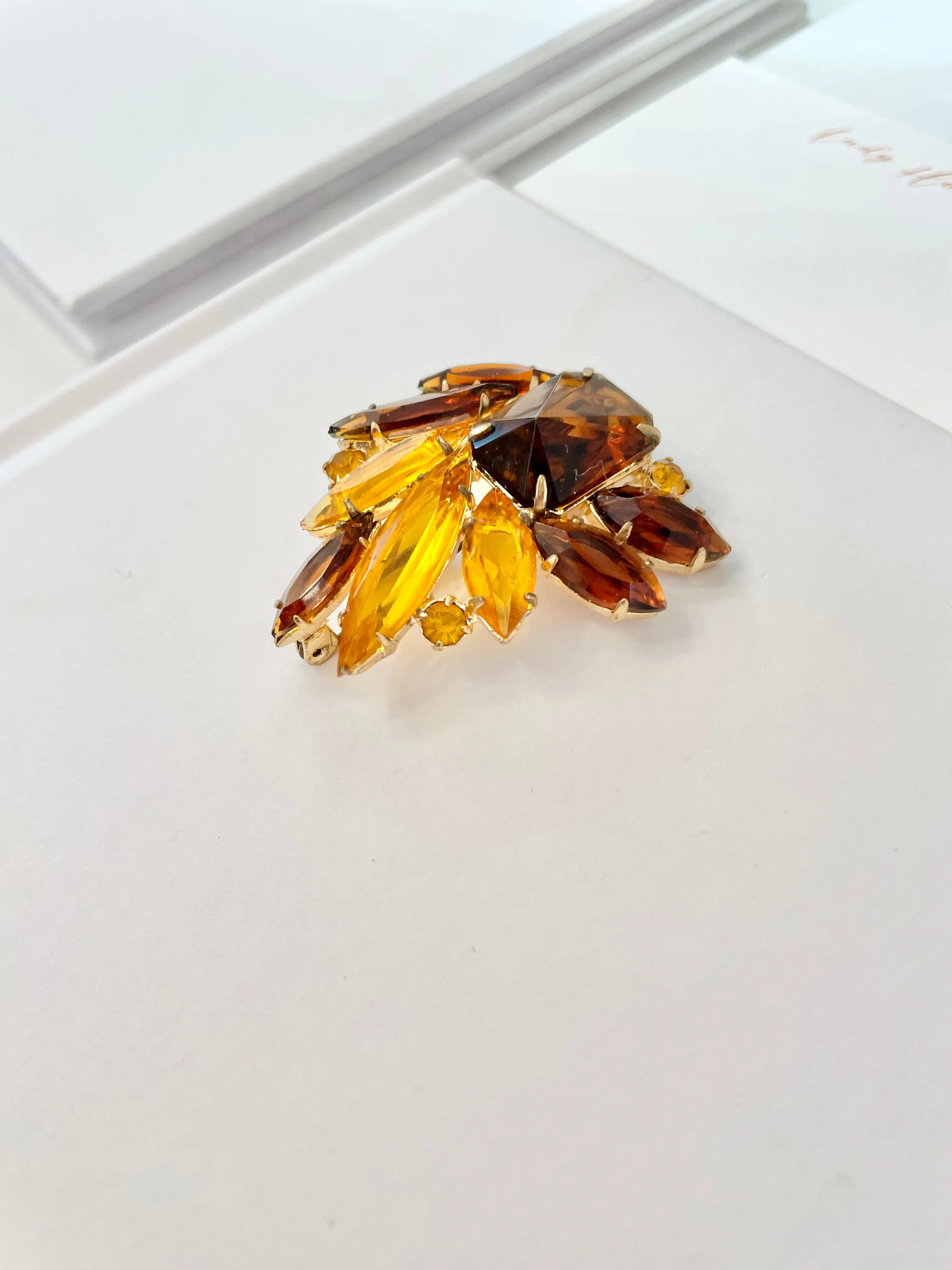 The Socialite and her love of the classic brooch. This 1960's faux glass smoky topaz brooch is truly divine!