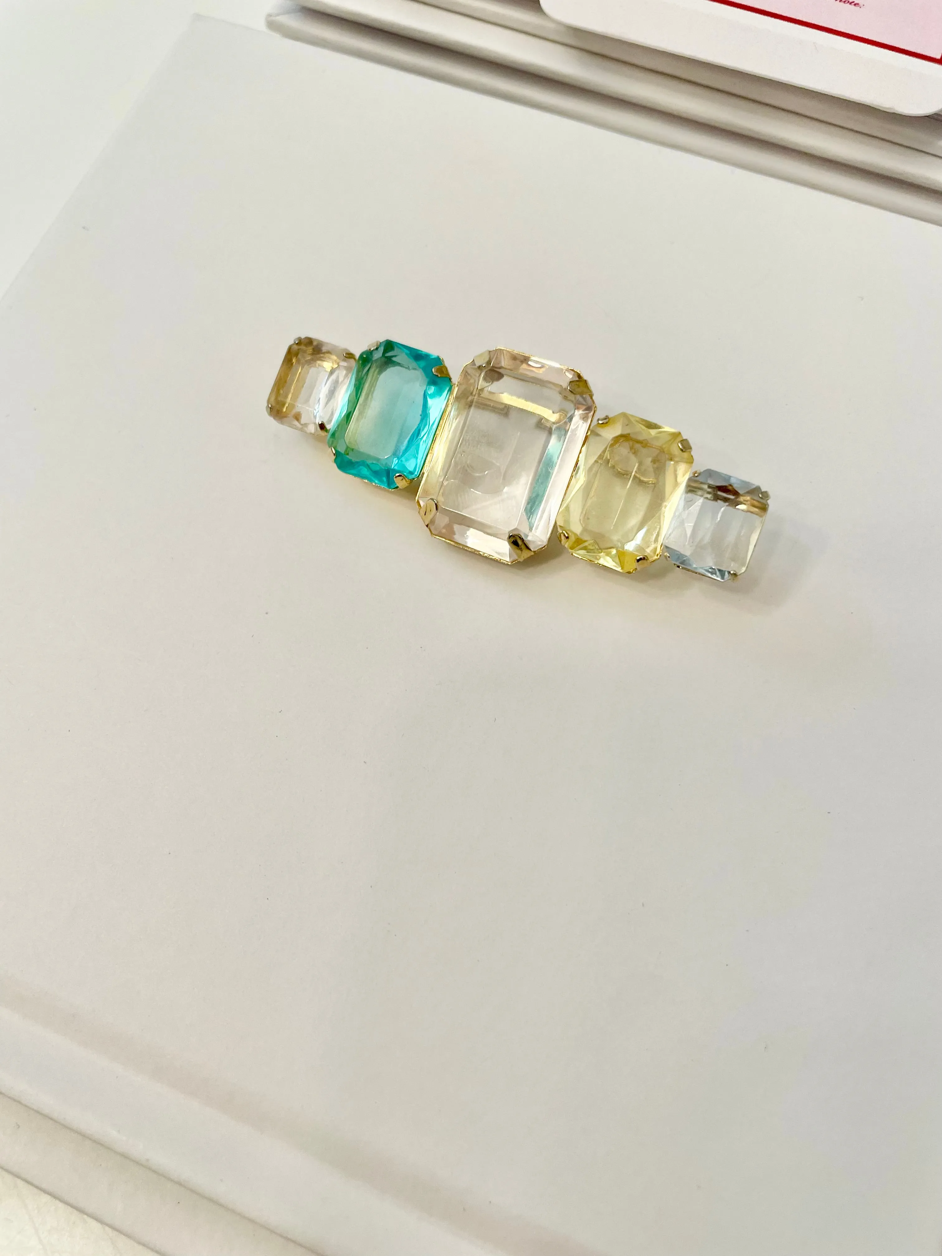 Truly stunning emerald cut stone brooch... so feminine!