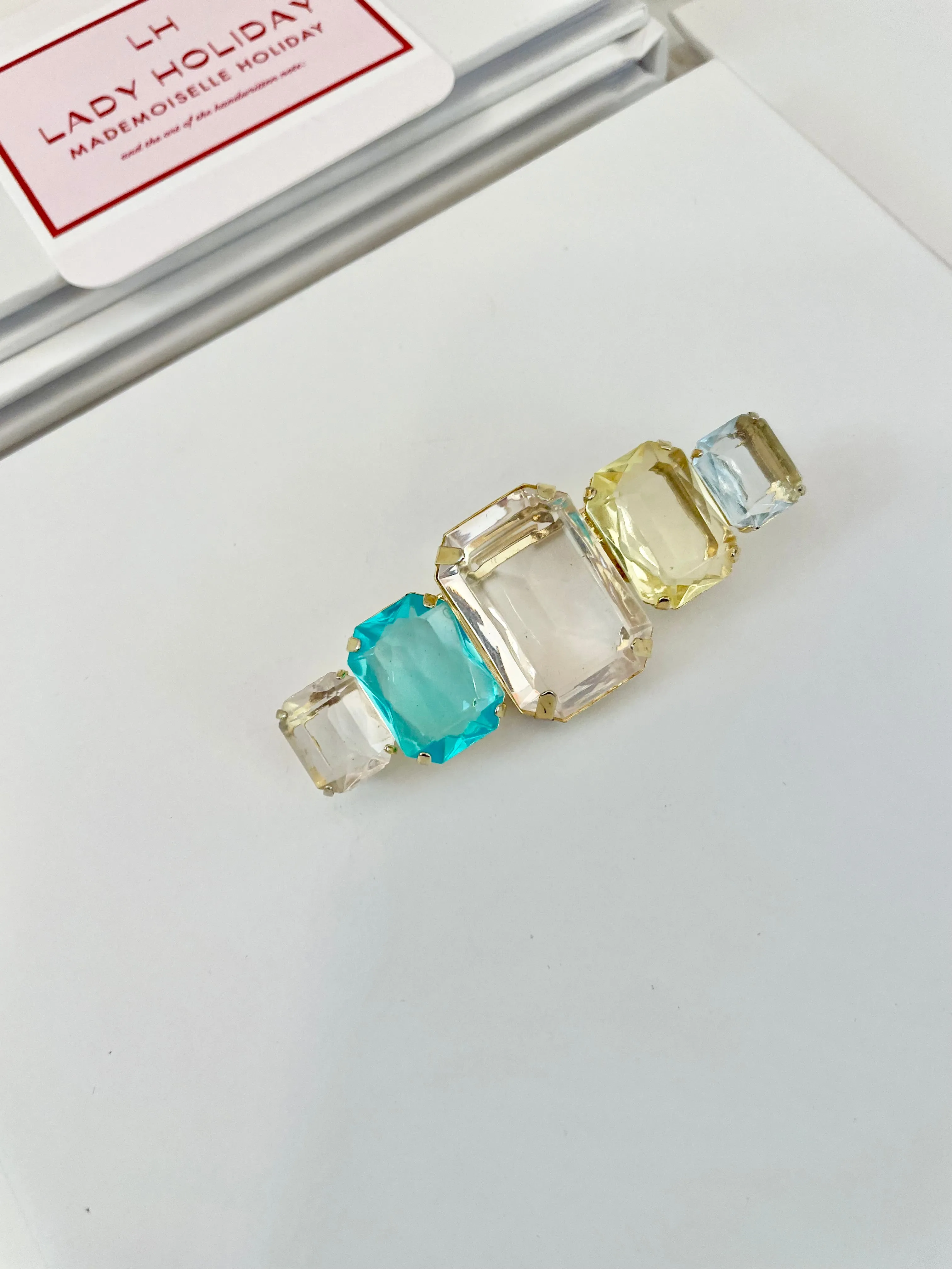 Truly stunning emerald cut stone brooch... so feminine!