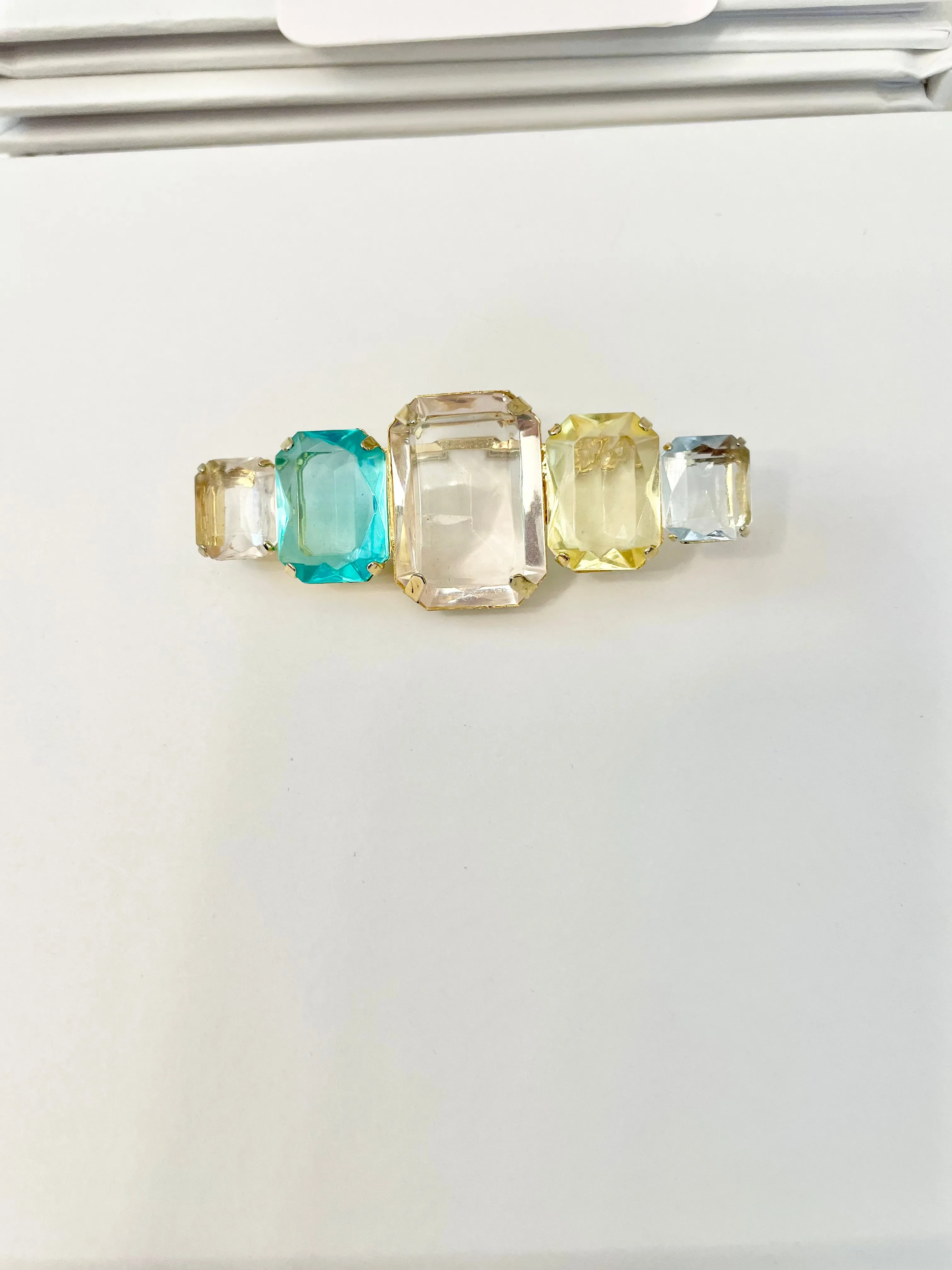 Truly stunning emerald cut stone brooch... so feminine!