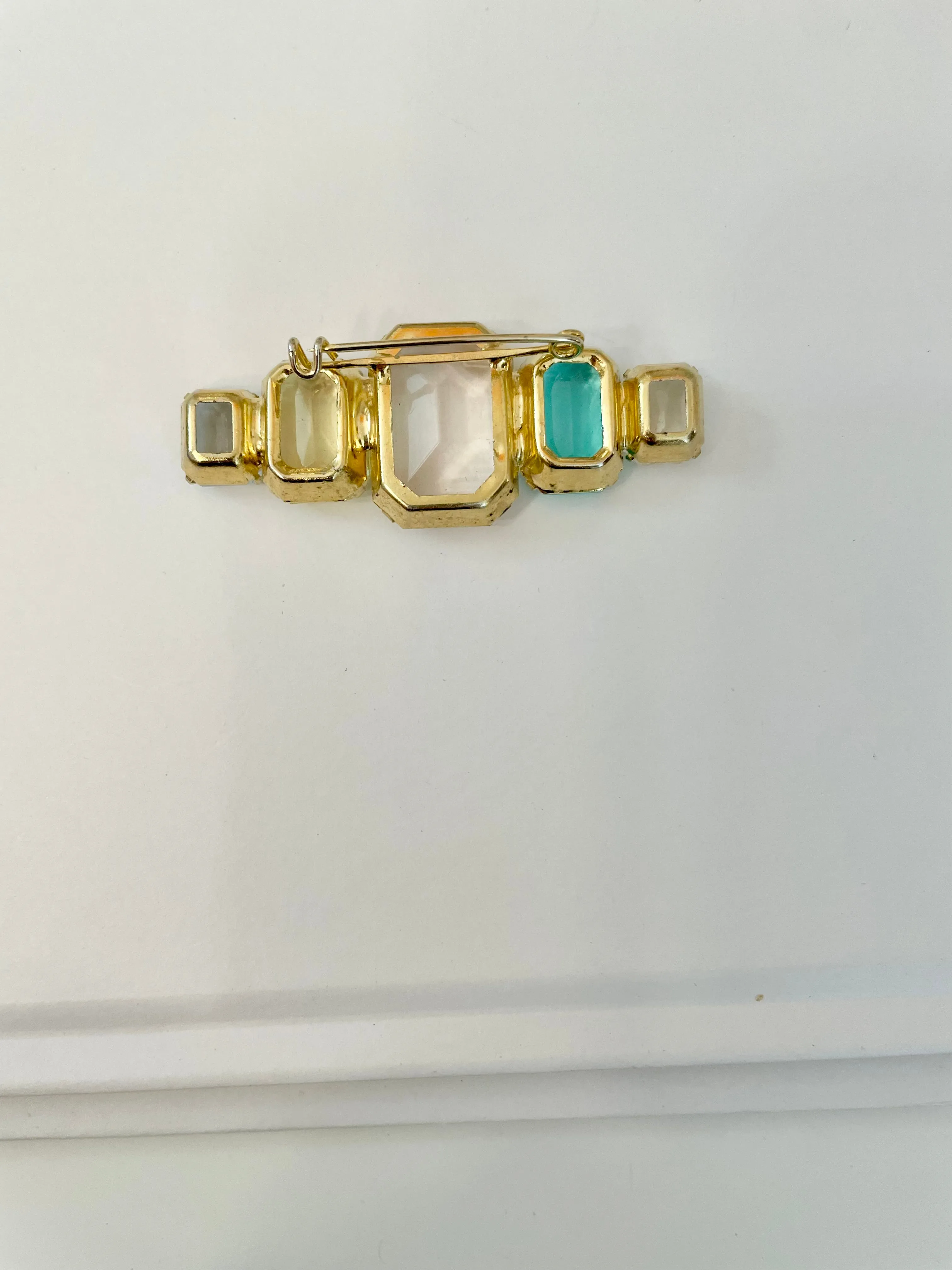 Truly stunning emerald cut stone brooch... so feminine!